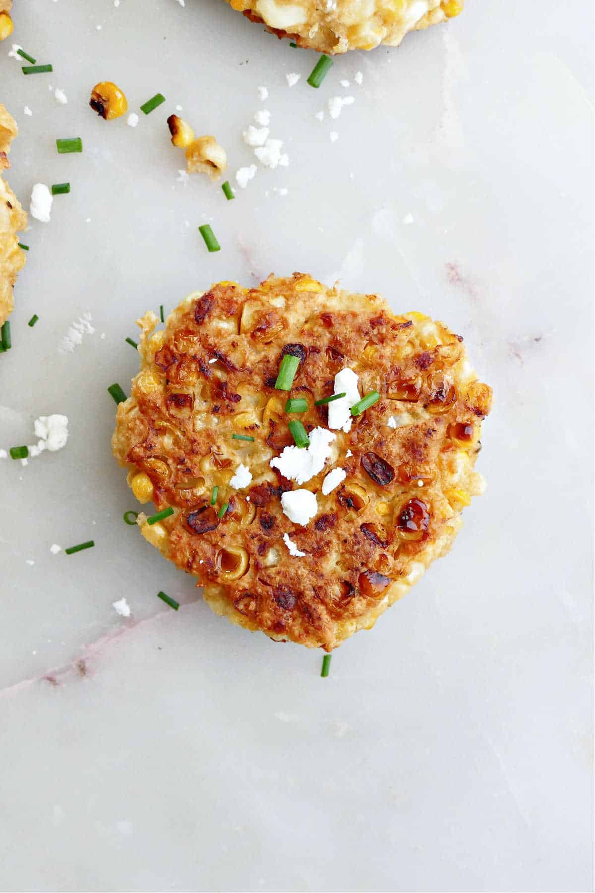 a single corn fritter made with 4 ingredients on a counter