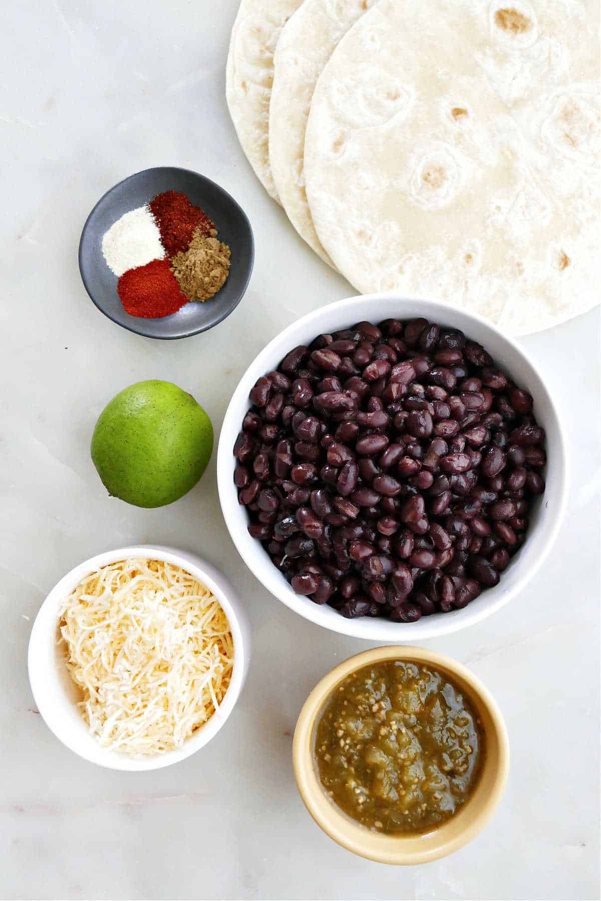tortillas, black beans, spices, lime, cheese, and salsa