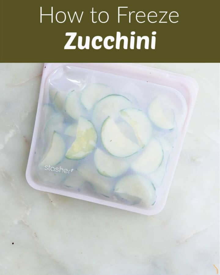 blanched zucchini slices in a silicone bag on a counter before being frozen with text box