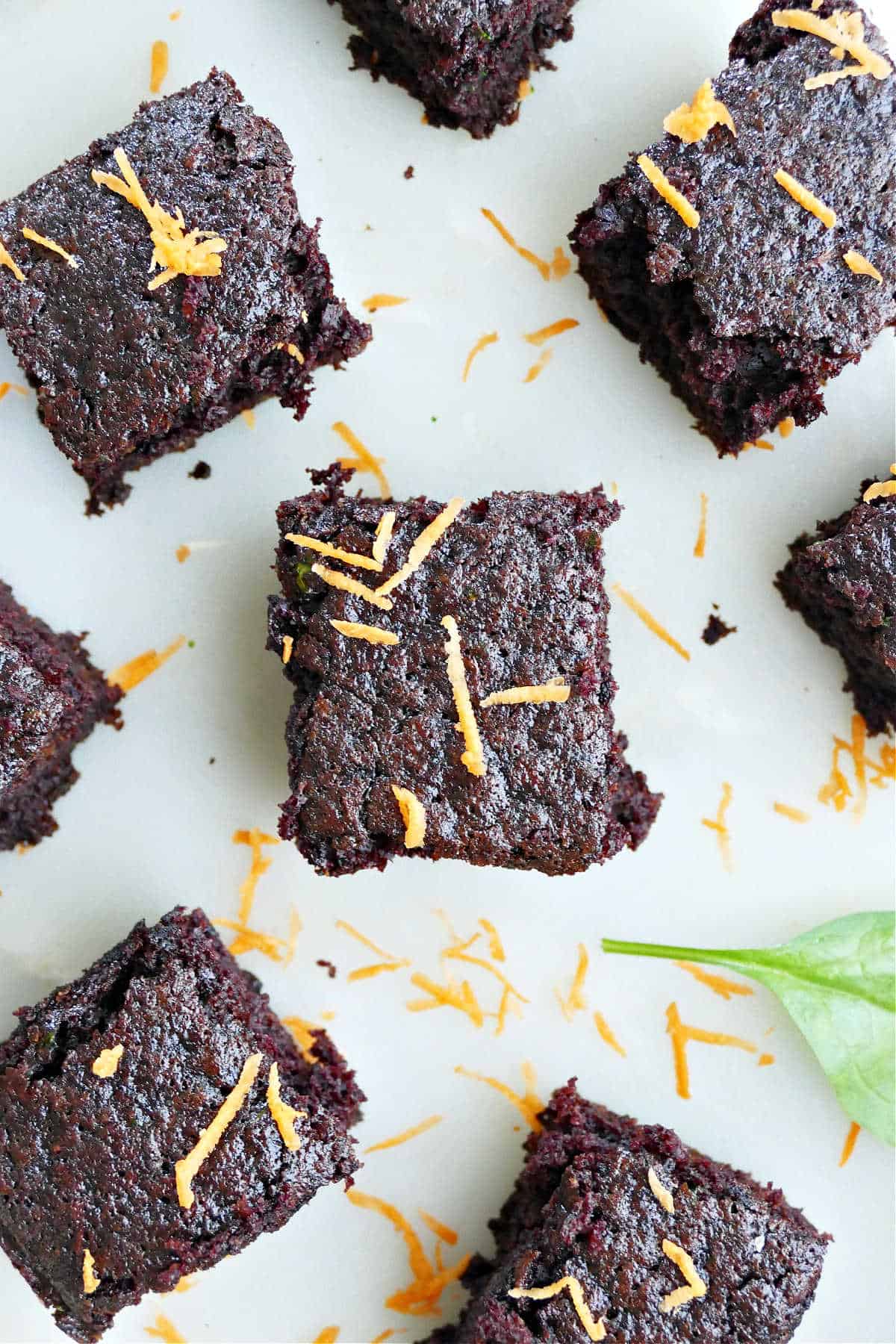 veggie brownies on a counter sprinkled with shredded carrots