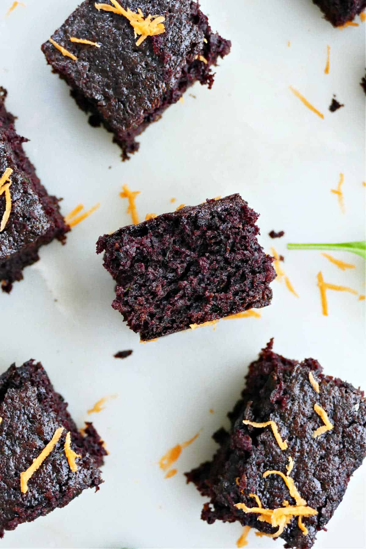 veggie brownie sliced with center showing in between other brownies on a counter