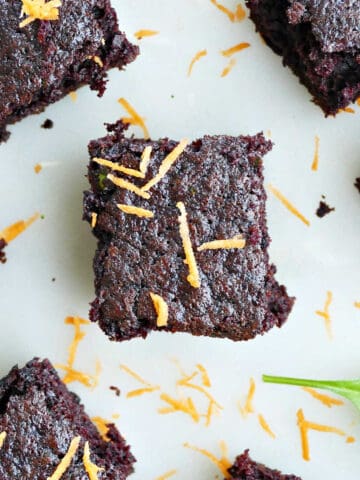 veggie brownies on a counter sprinkled with shredded carrots