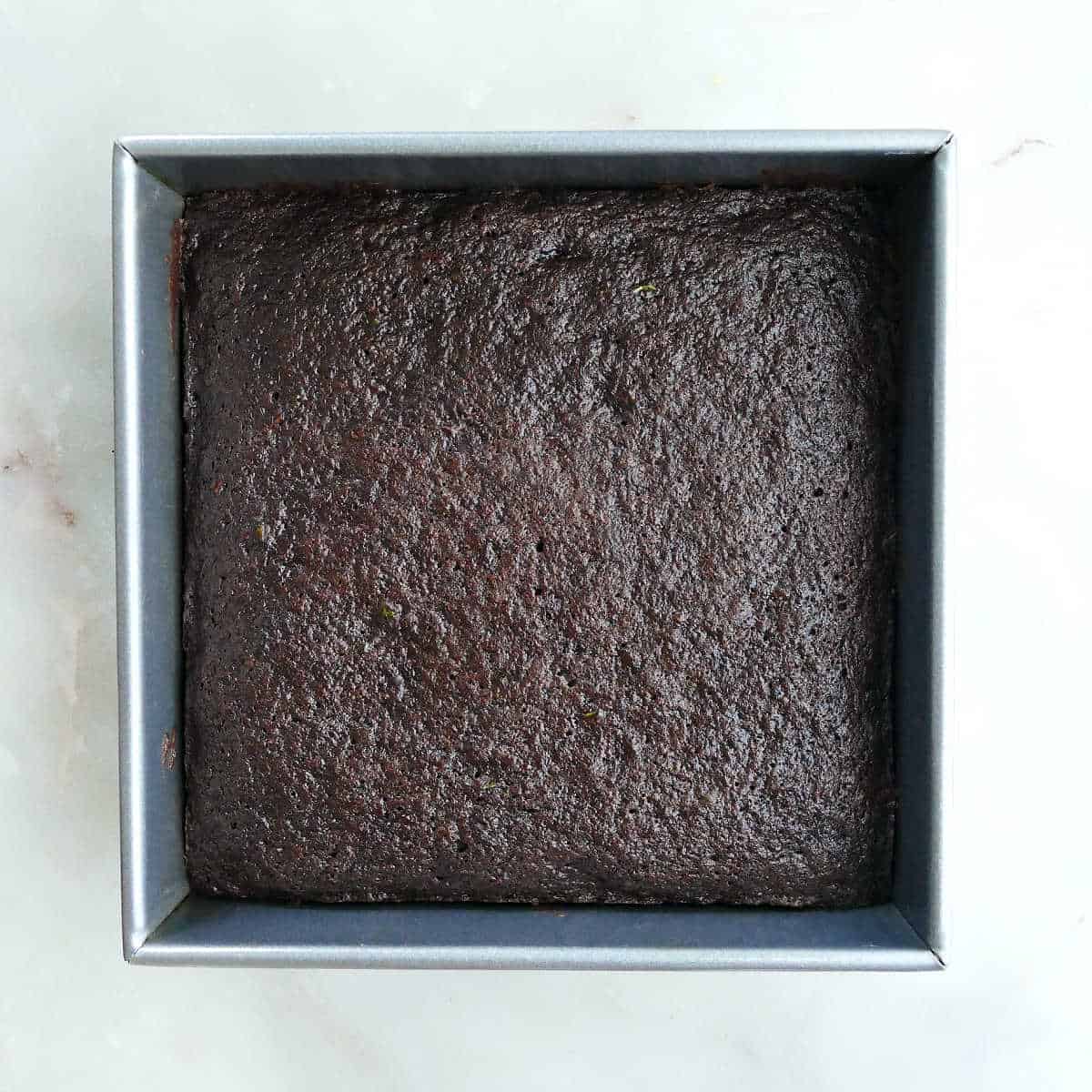veggie brownies in a square baking dish after being baked on a counter