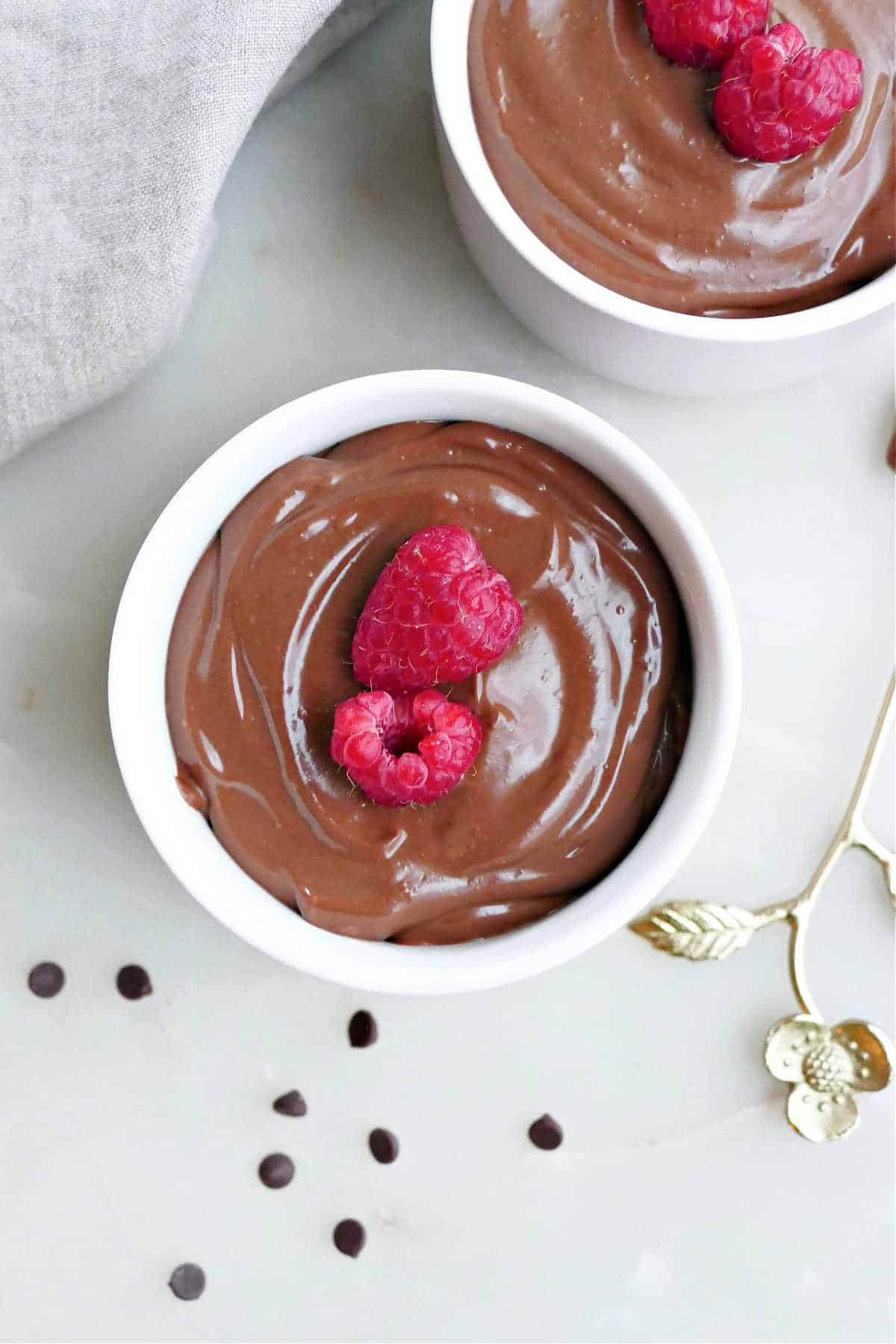 tofu chocolate mousse in a bowl with berries on a counter