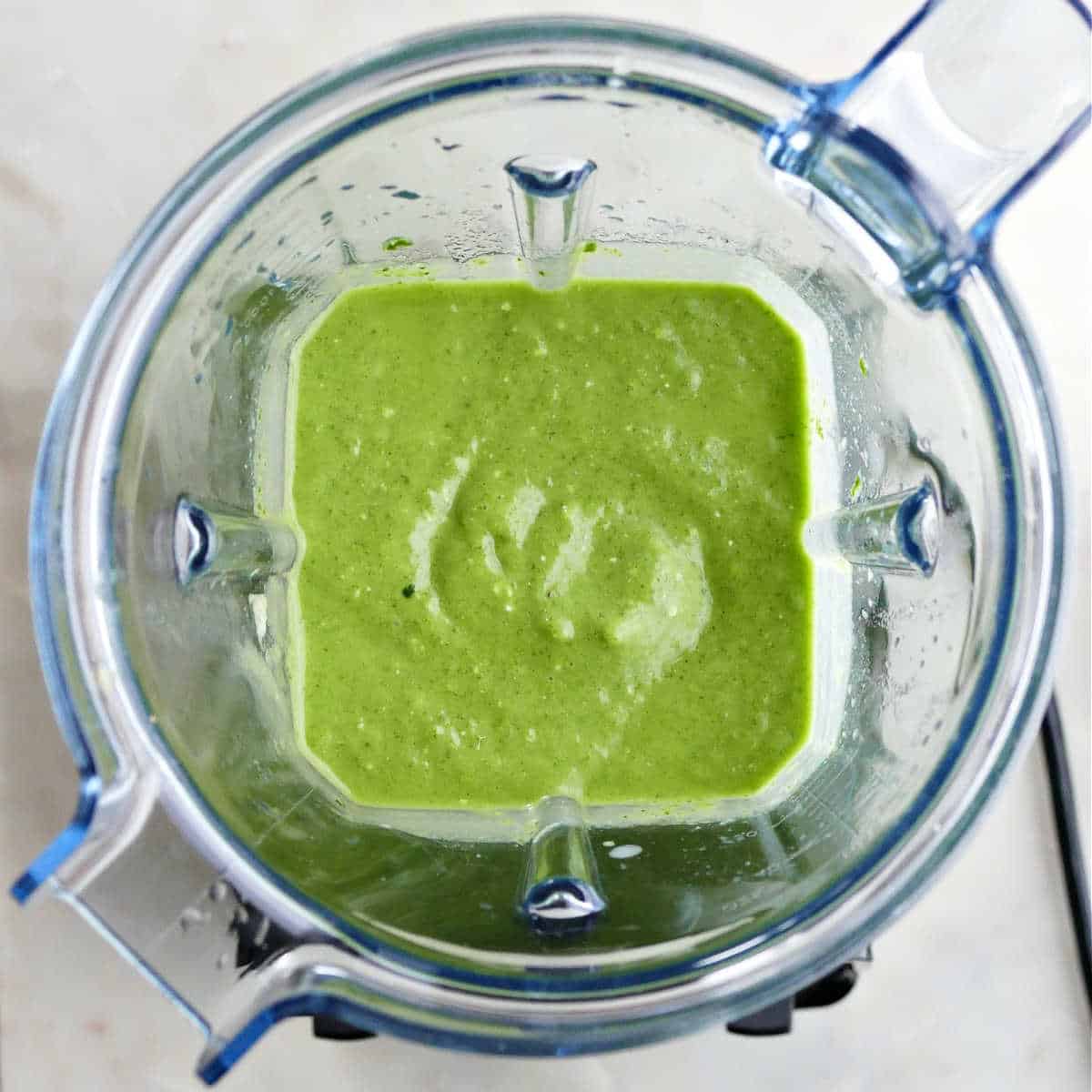 green smoothie in a high-powered blender after being blended