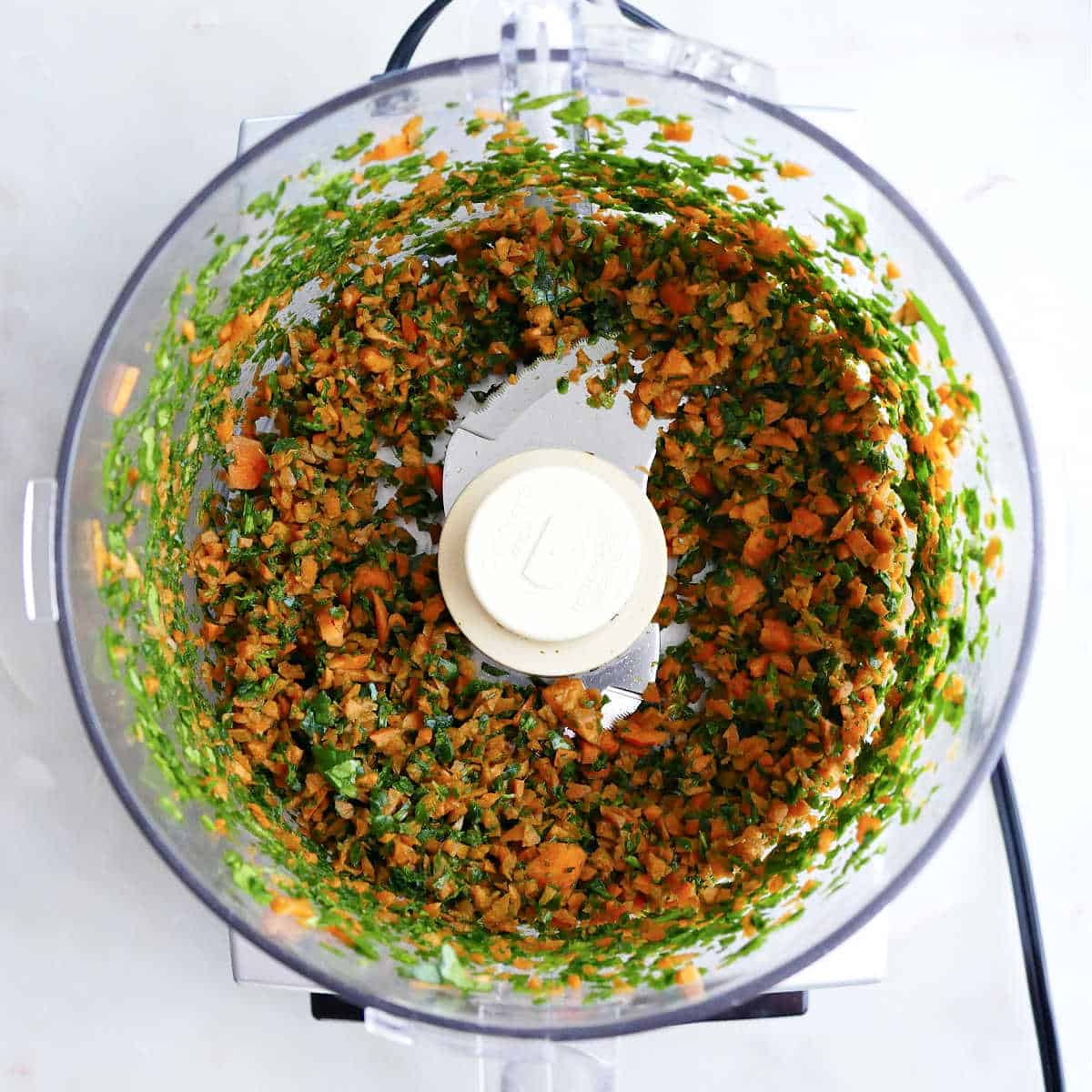 Spinach and carrots blended in a food processor.