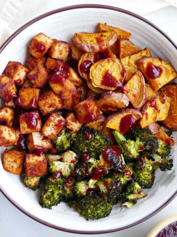 Bbq marinated tofu topped with sauce on a plate with broccoli.
