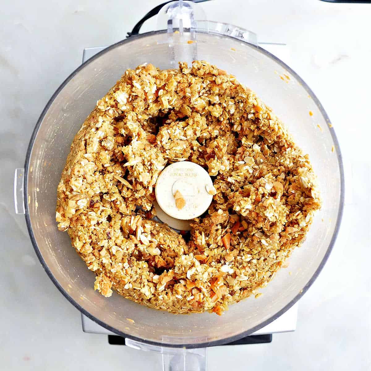 Carrot cake bar mixture in a food processor with the lid off.