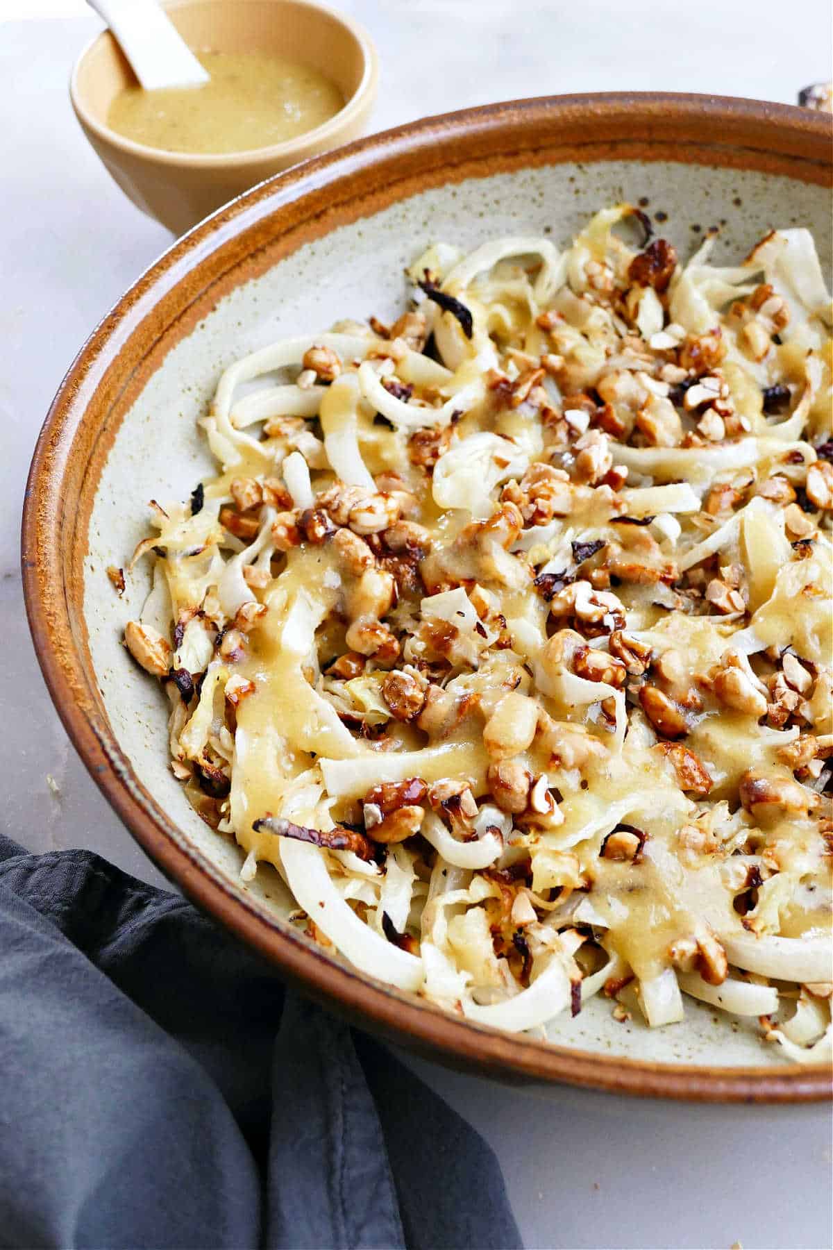 Roasted cabbage salad in a large bowl with nuts.
