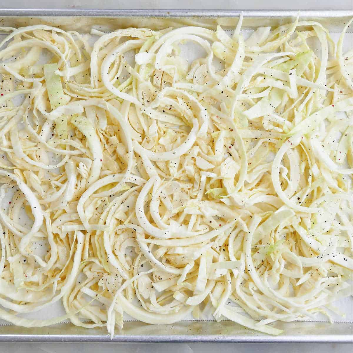 Shredded cabbage on a baking sheet.