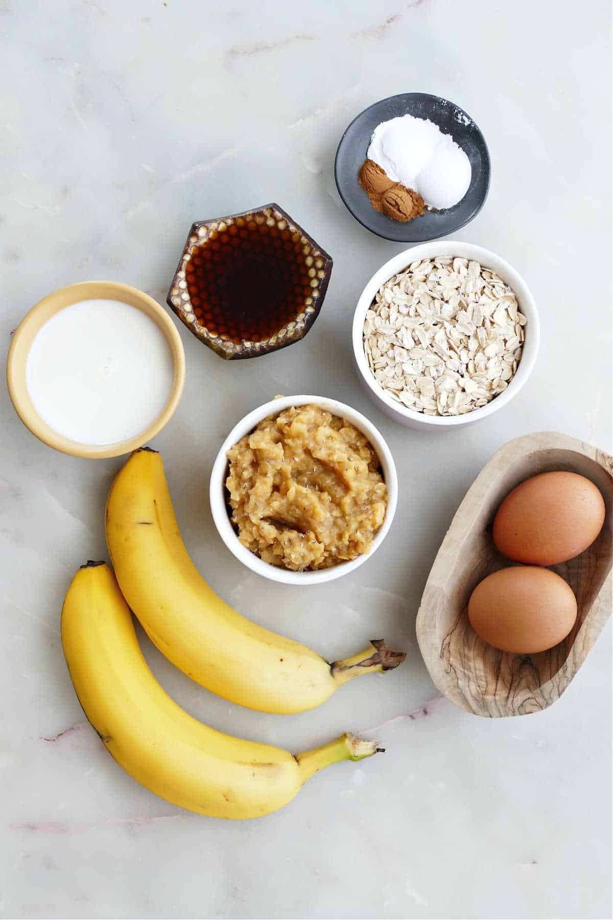 Ingredients needed to make baked banana pancakes on a sheet pan.
