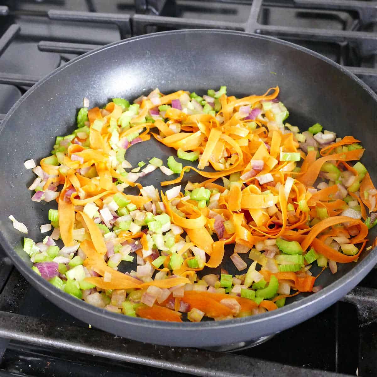 Sautéing veggies in a large skillet.