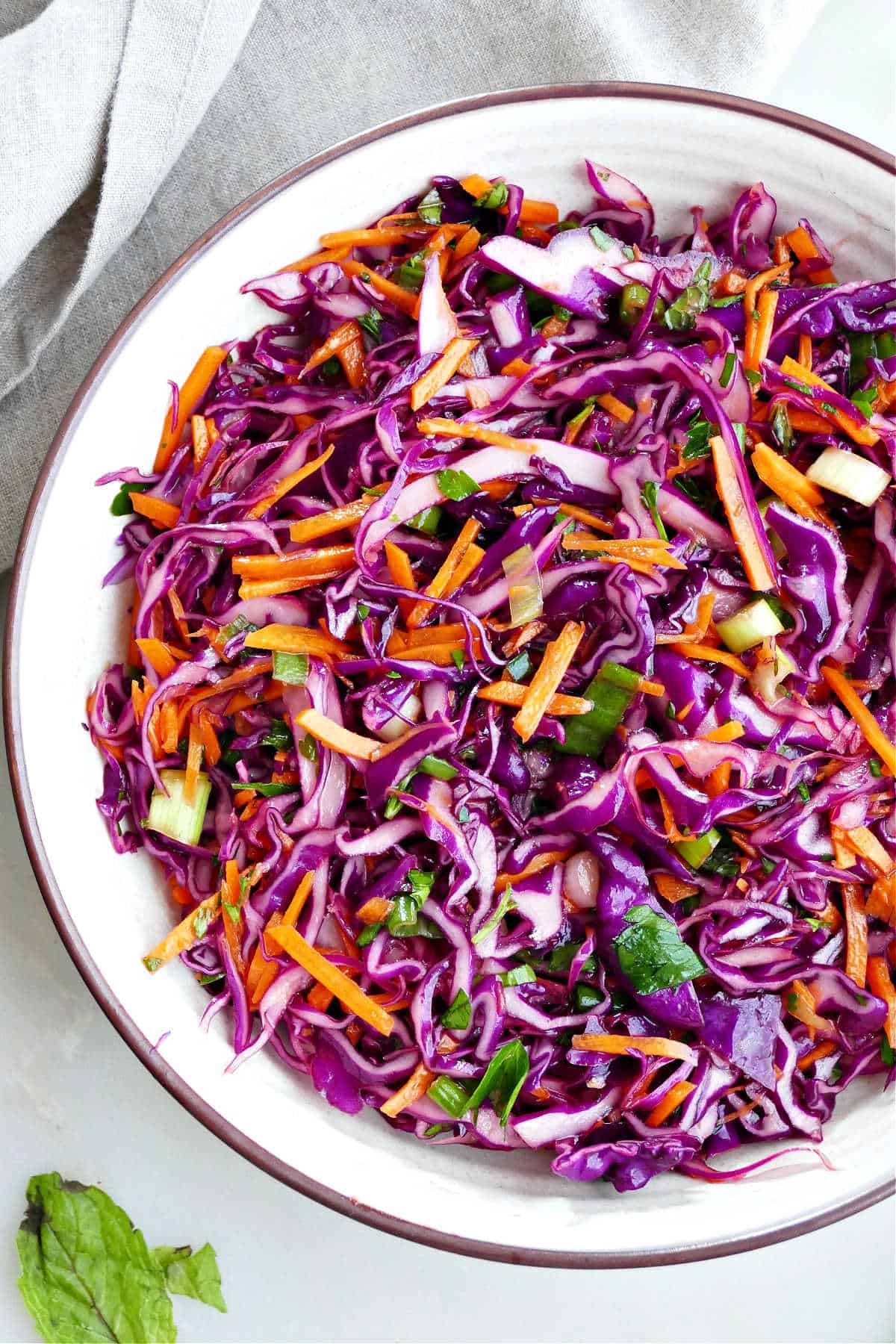 Simple cabbage carrot slaw in a serving bowl.