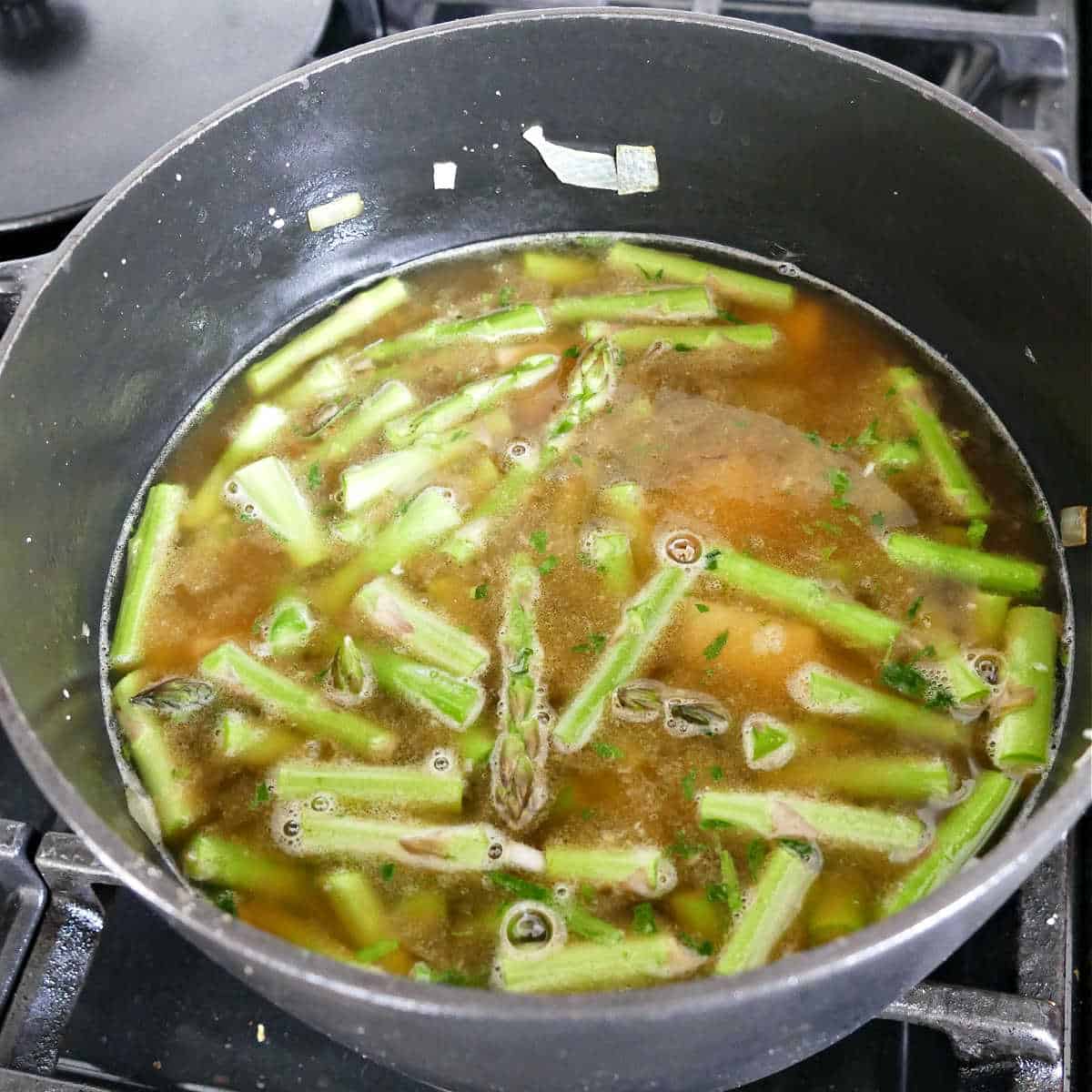 Cooking the asparagus in a large stock pot.