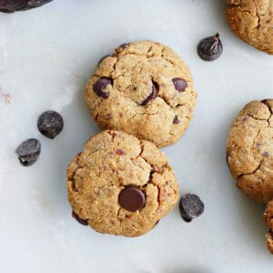 Close up of two sweetened date cookies with chocolate chips.