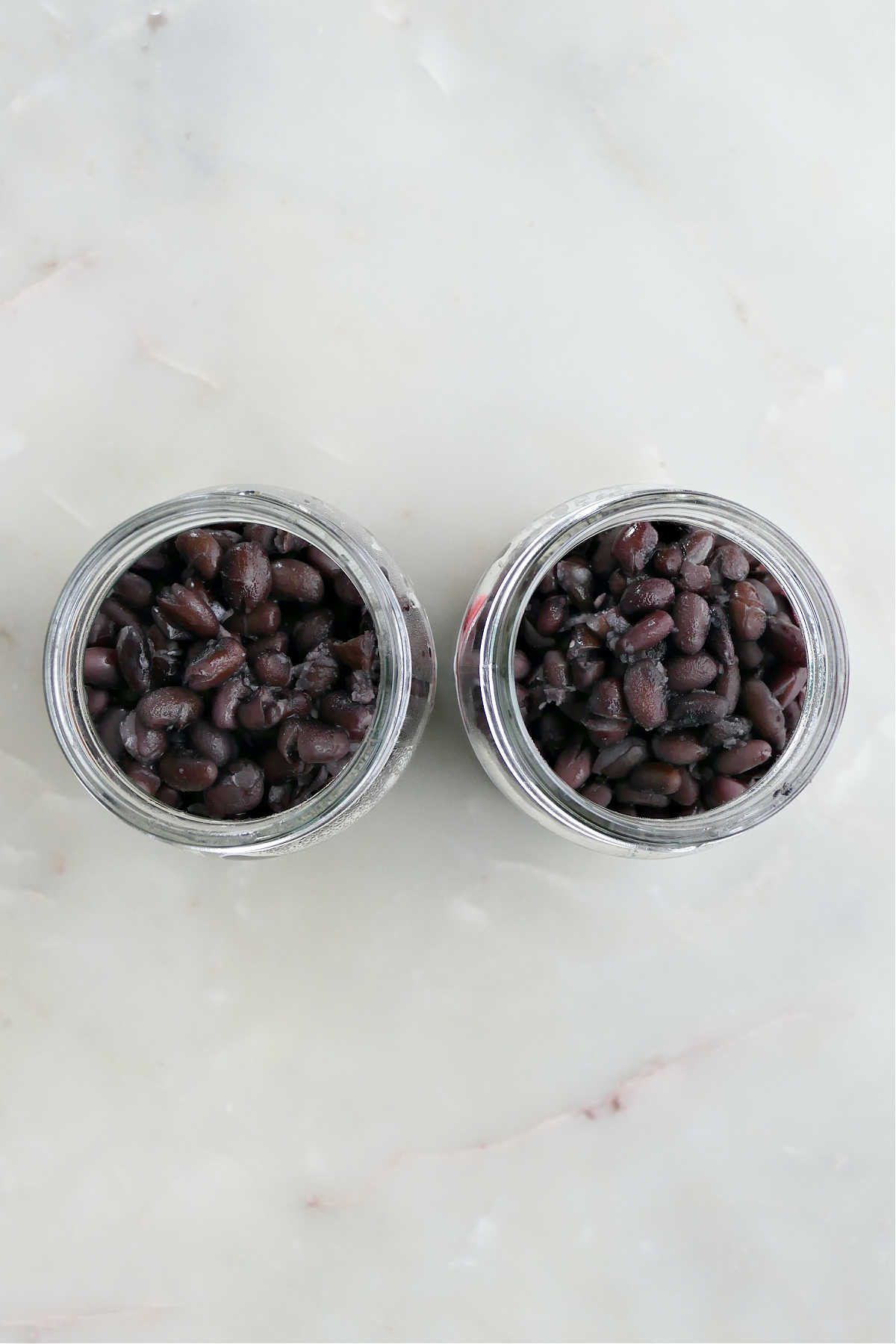 Two mason jars of stove top cooked black beans.