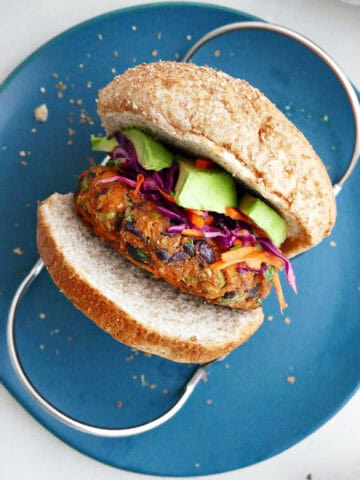 Top view of a sweet potato black bean burger with avocado and slaw.