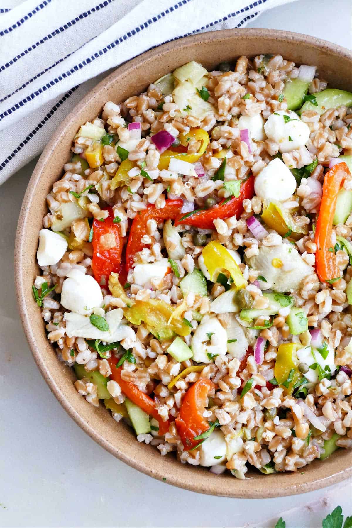 Italian farro salad in a bowl with Mediterranean veggies.