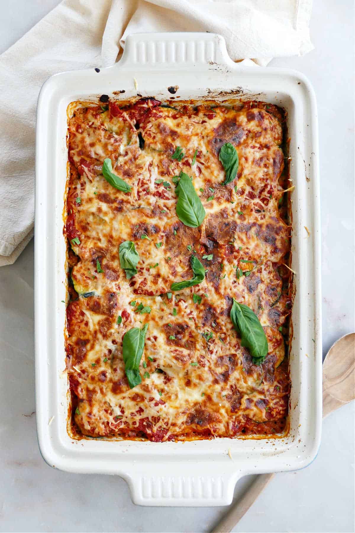 A white baking dish of zucchini ground beef casserole before serving.