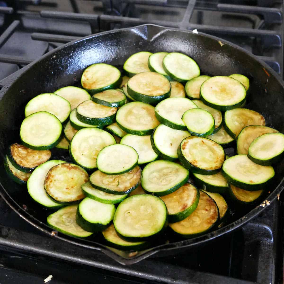 Sauteeing the zucchini in a skillet.