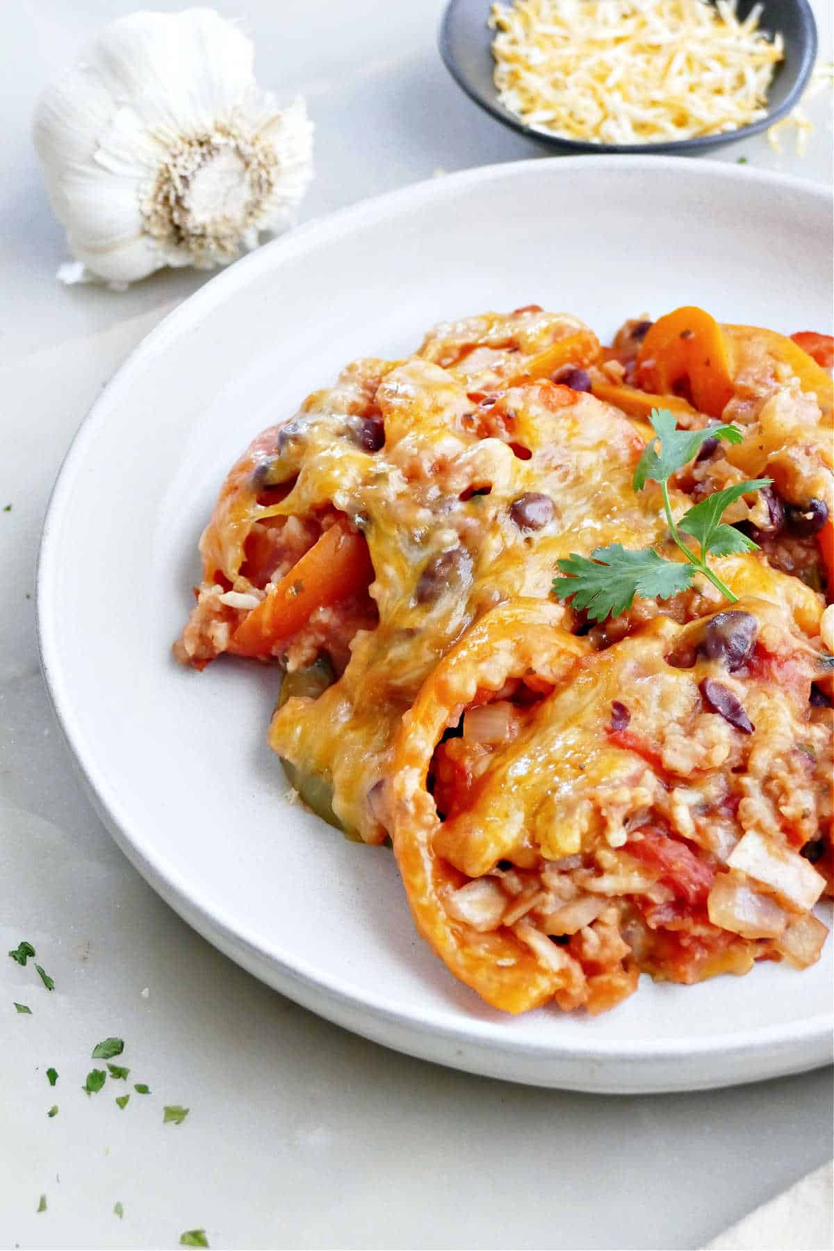 Unstuffed bell pepper casserole on a plate next to leftover ingredients.