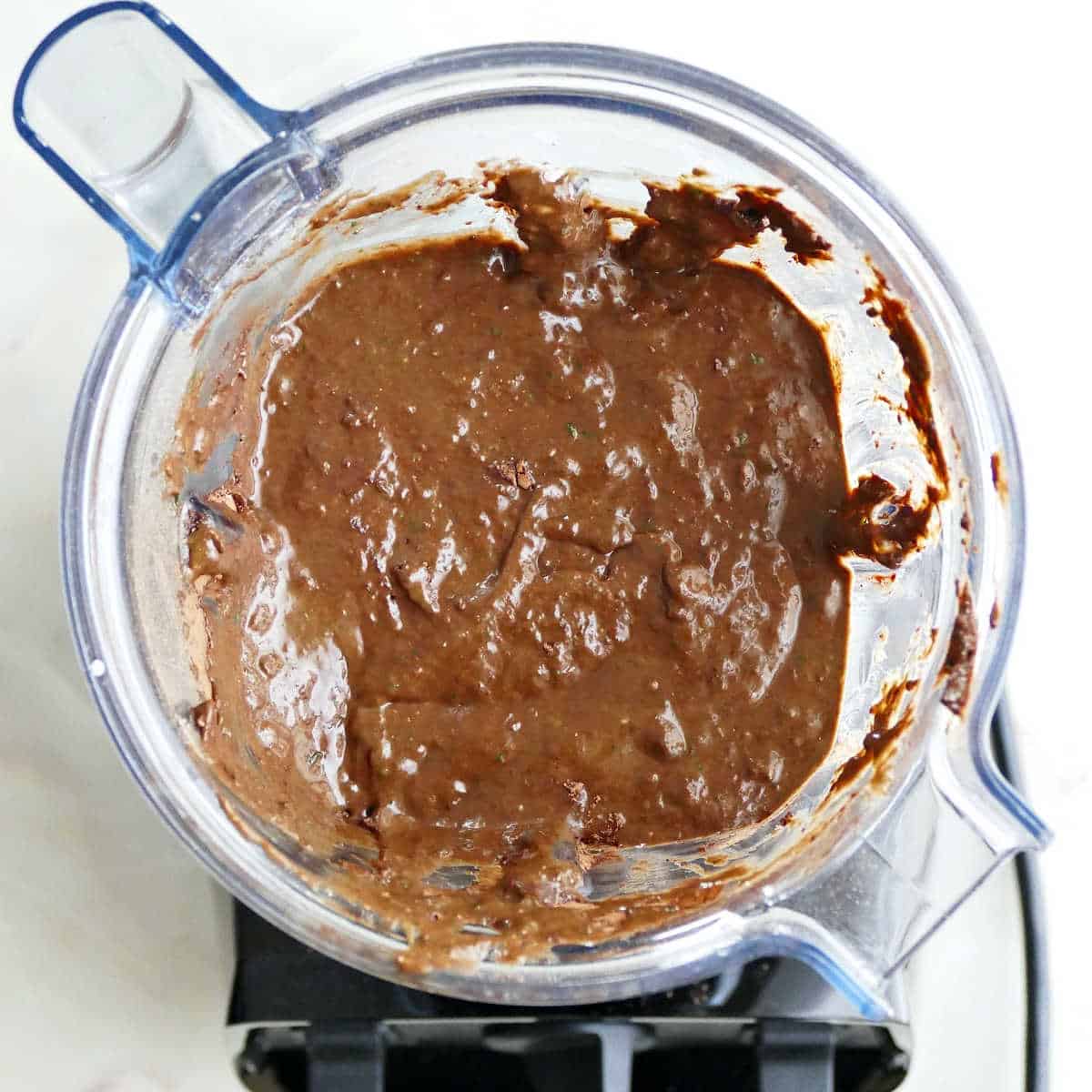 Blended batter for healthy chocolate muffins in a blender.