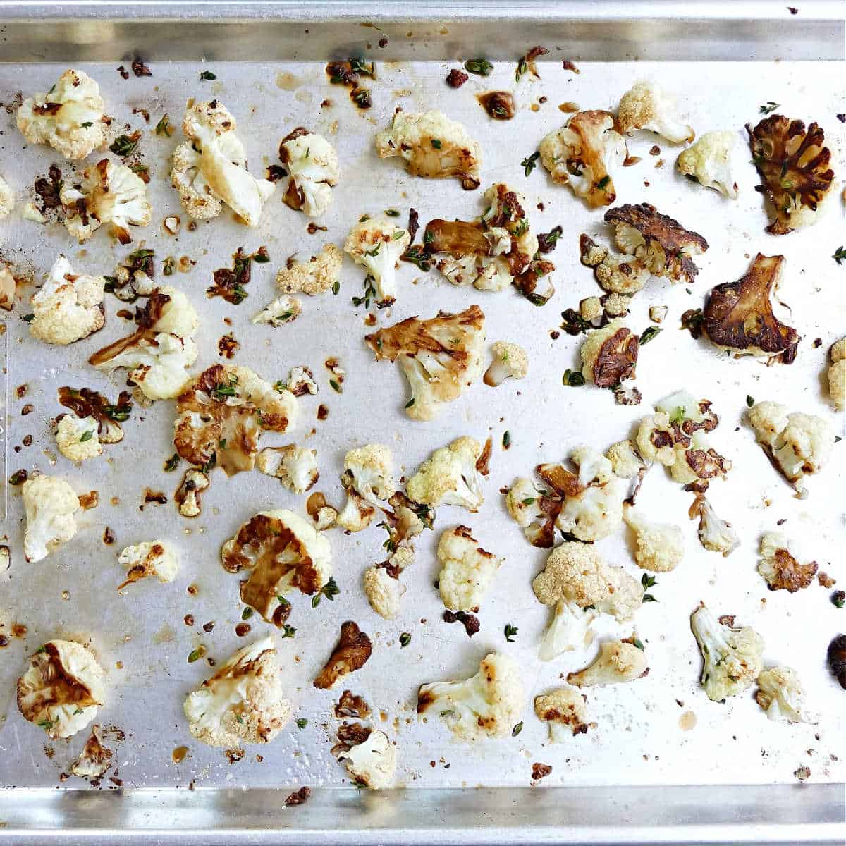 Balsamic roasted cauliflower on a large rimmed baking sheet.