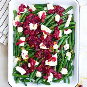 Fresh holiday green beans topped with brie cheese and cranberry suace.