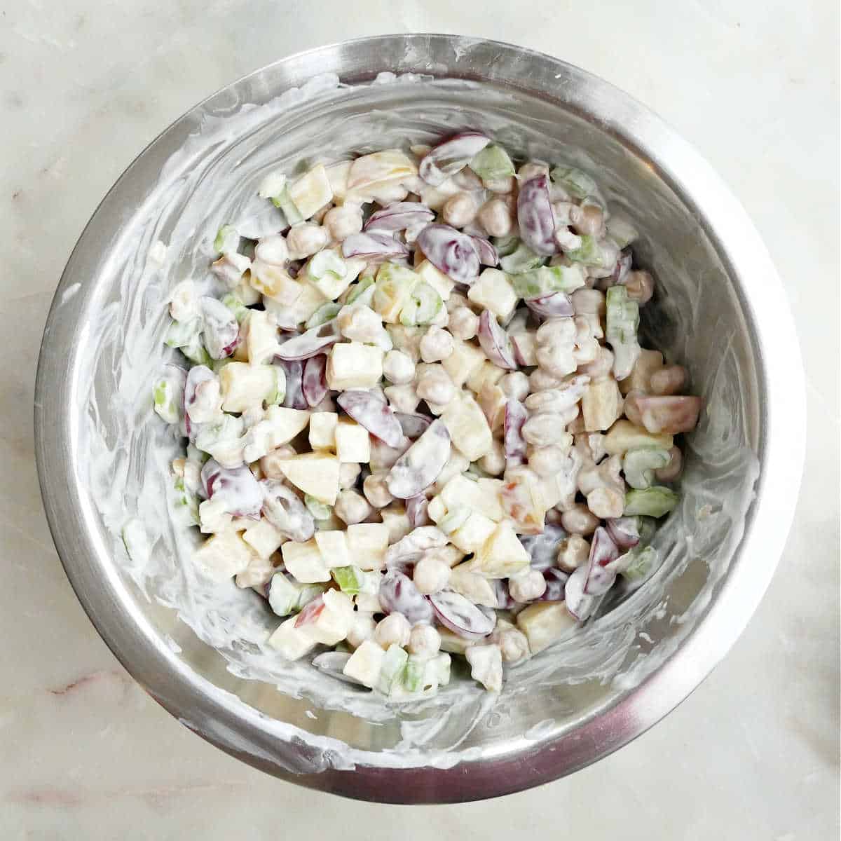 Mixed waldorf salad in a mixing bowl.