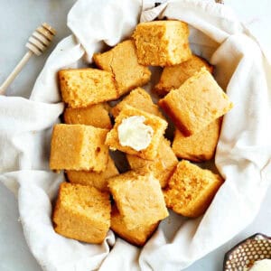 A basket of homemade sweet potato cornbread slices.