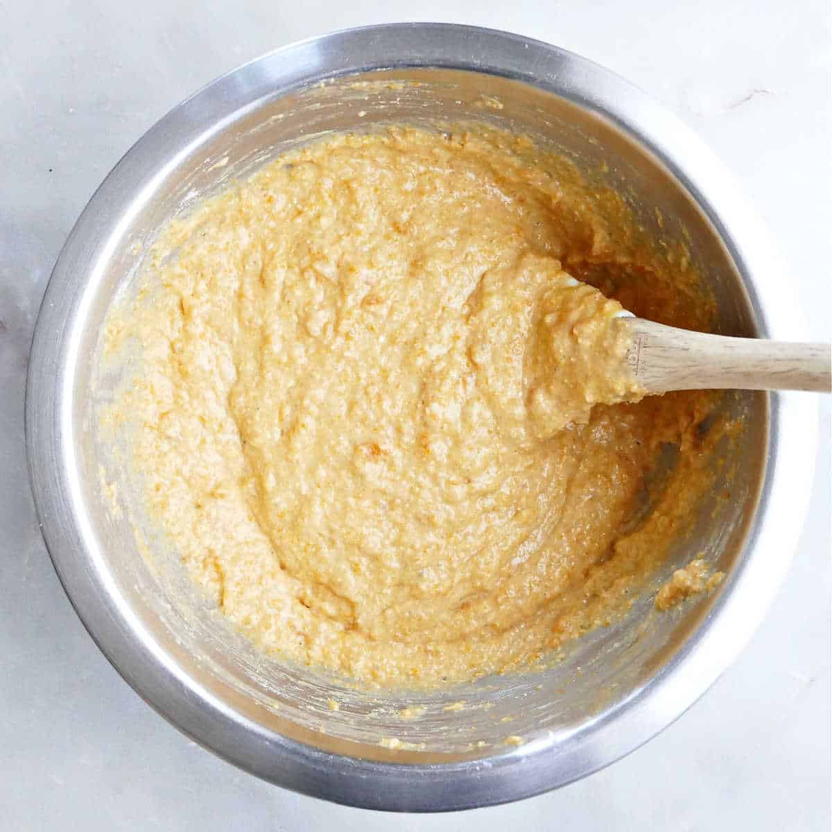 Stirring in the cornmeal to the sweet potato mixture.