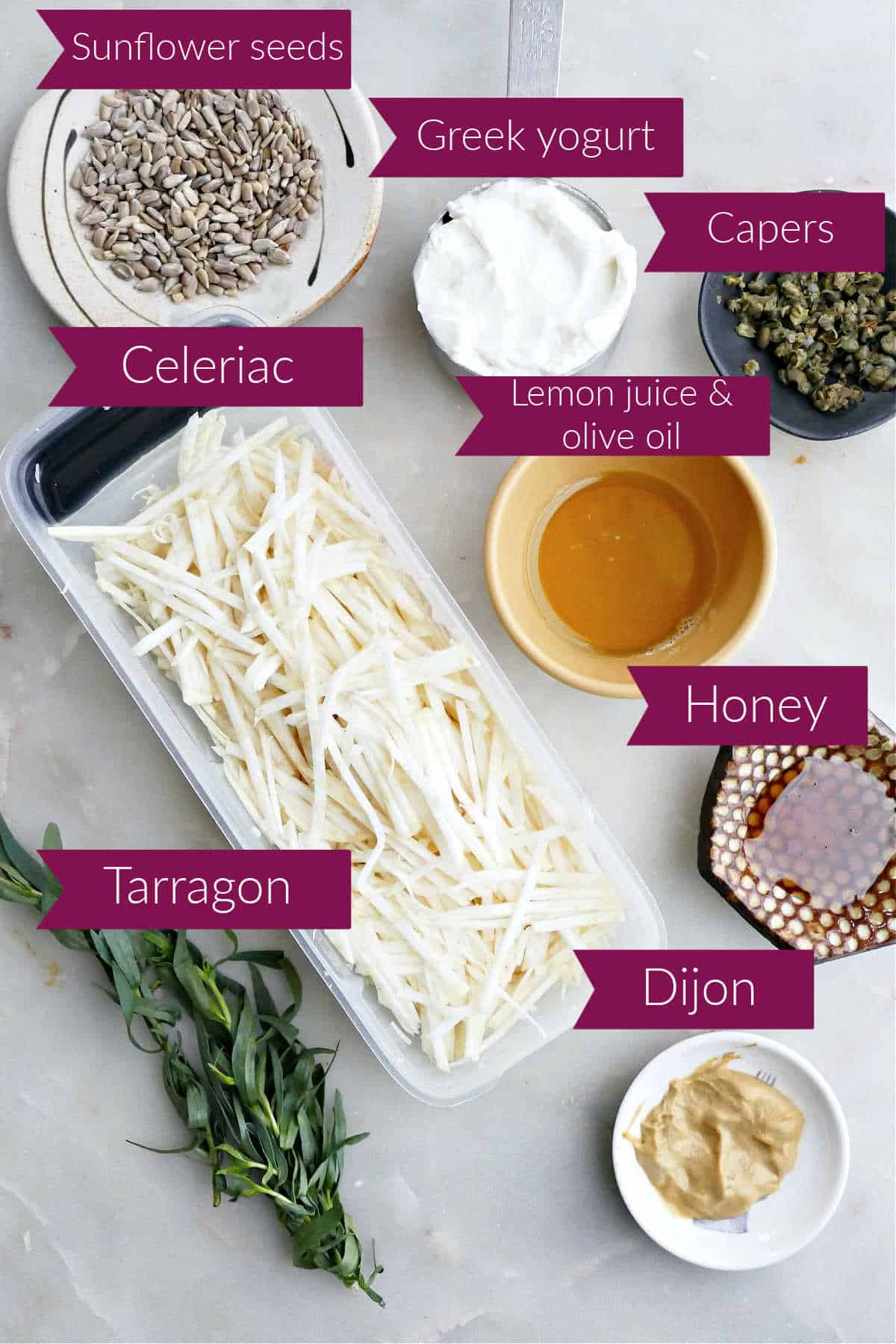 Ingredients for celery root coleslaw on a counter with labels.