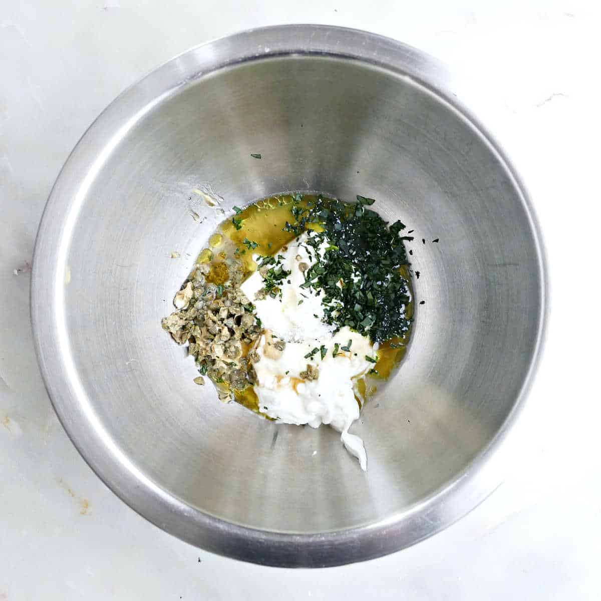 Ingredients for yogurt remoulade-style dressing in a mixing bowl.