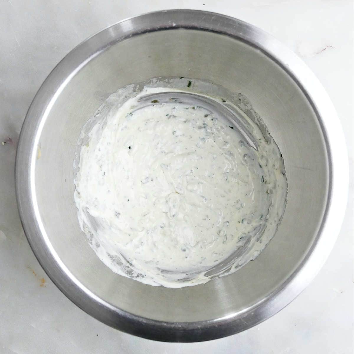 Tarragon yogurt dressing after being mixed together in a bowl.