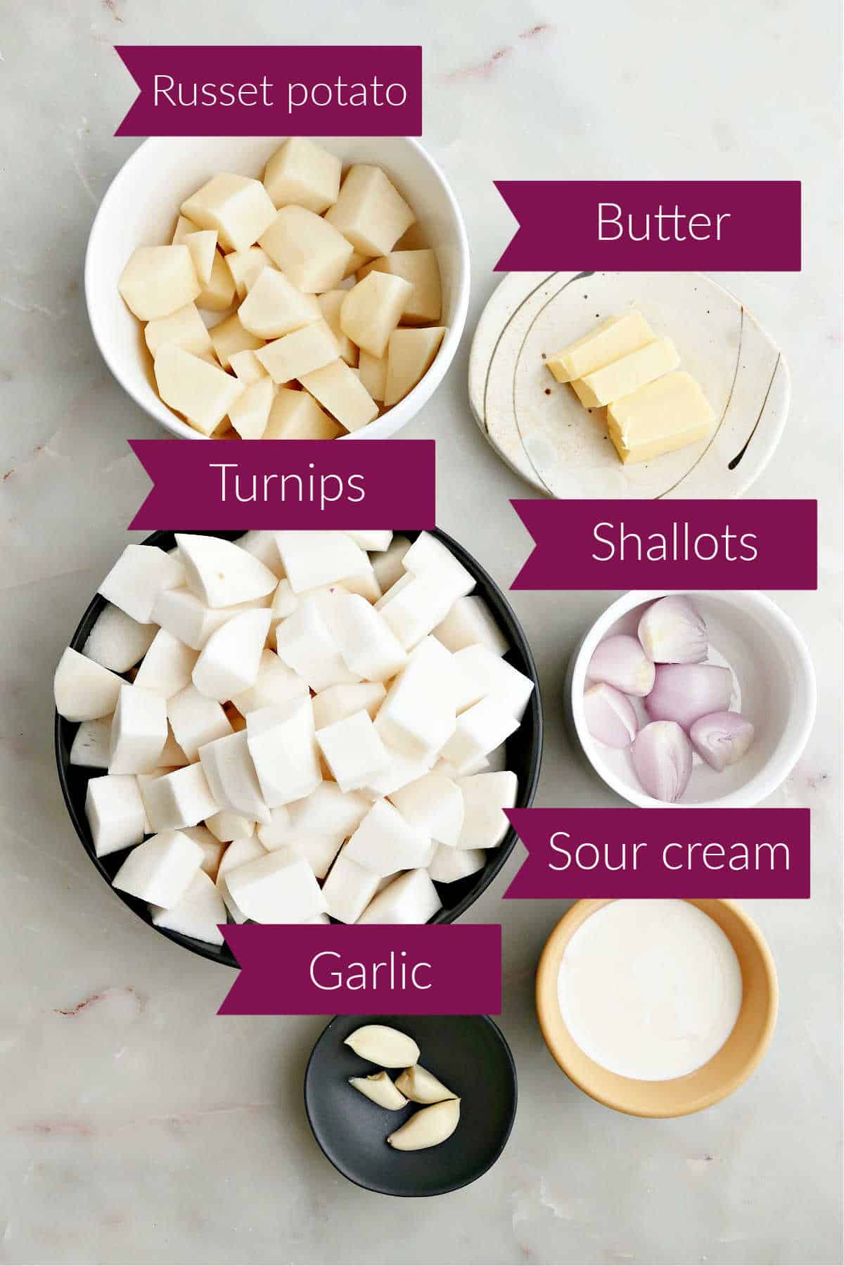 Ingredients for mashed turnips in bowls on a counter with labels.