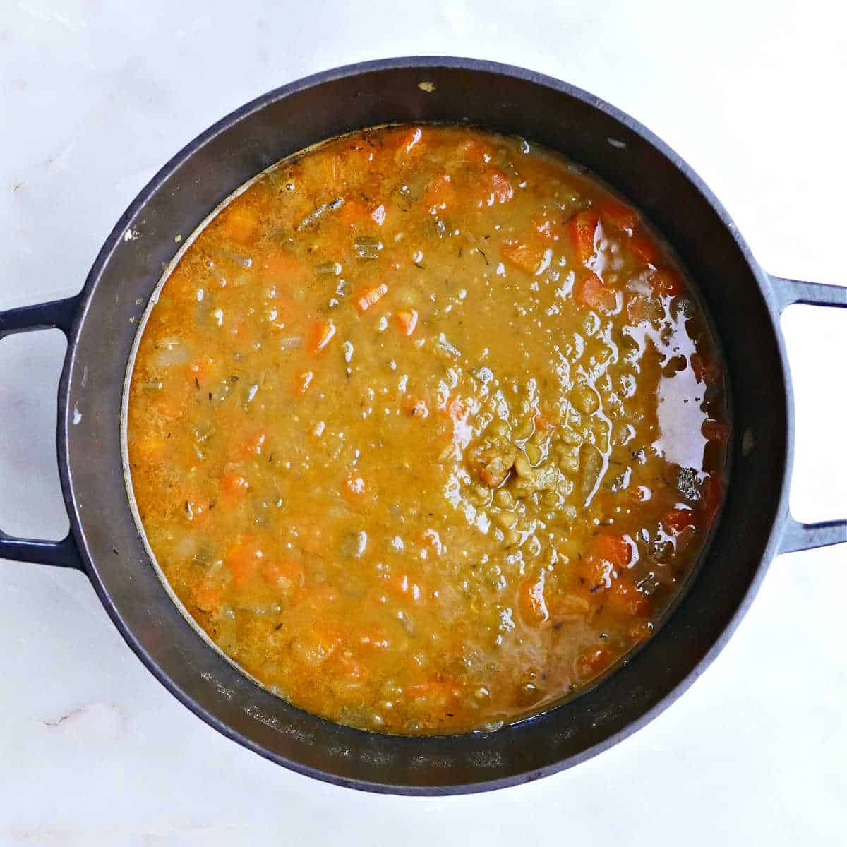 Split pea soup after it's finished cooking in a large soup pot.