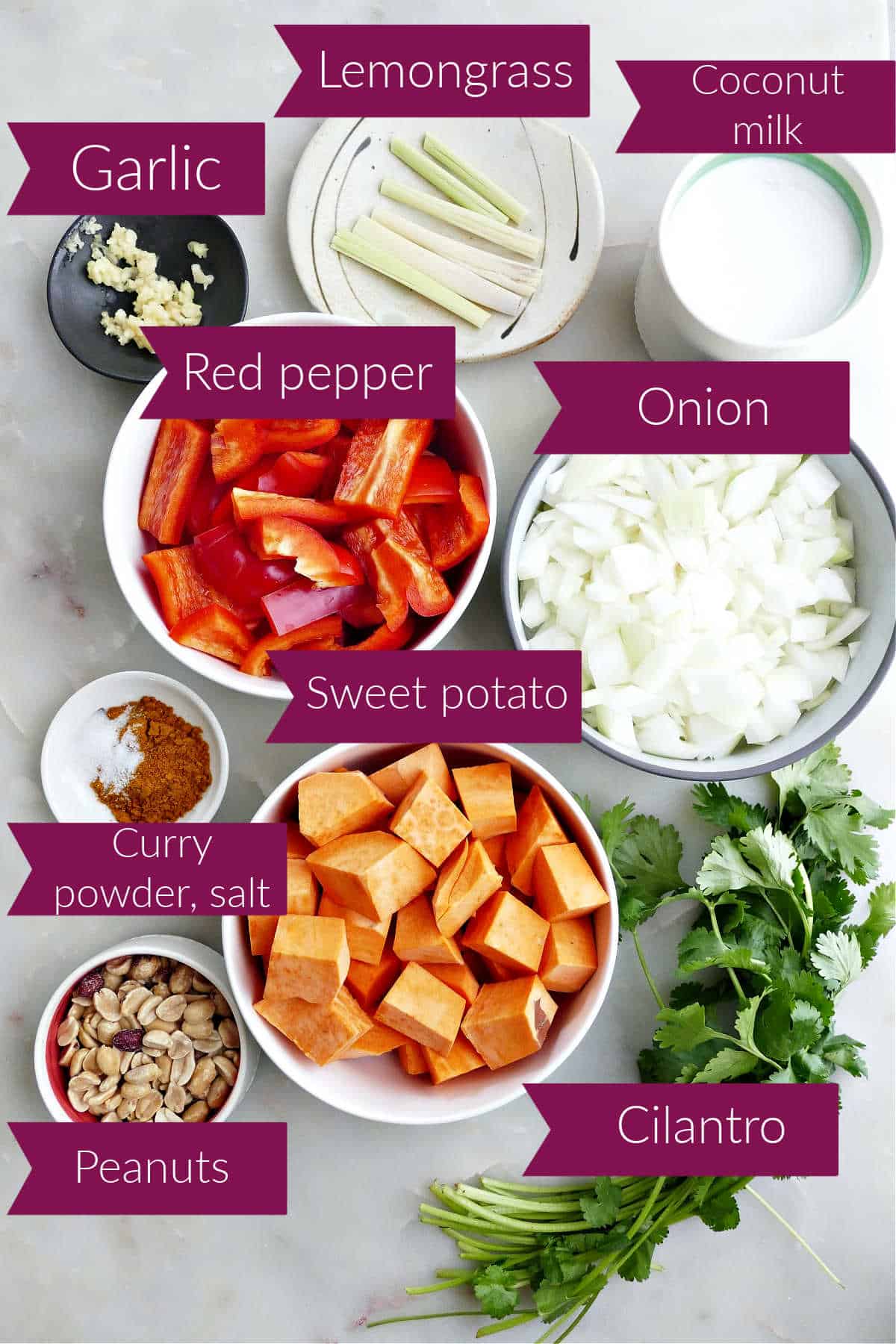 Ingredients for sweet potato soup with red pepper on a counter with labels.