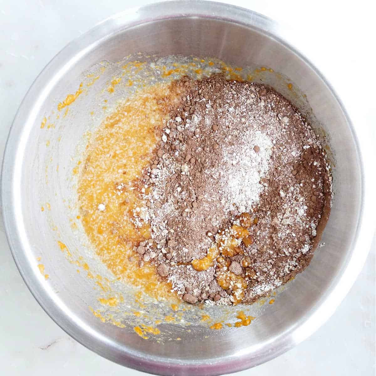 Wet ingredients for chocolate sweet potato cupcakes in a mixing bowl.