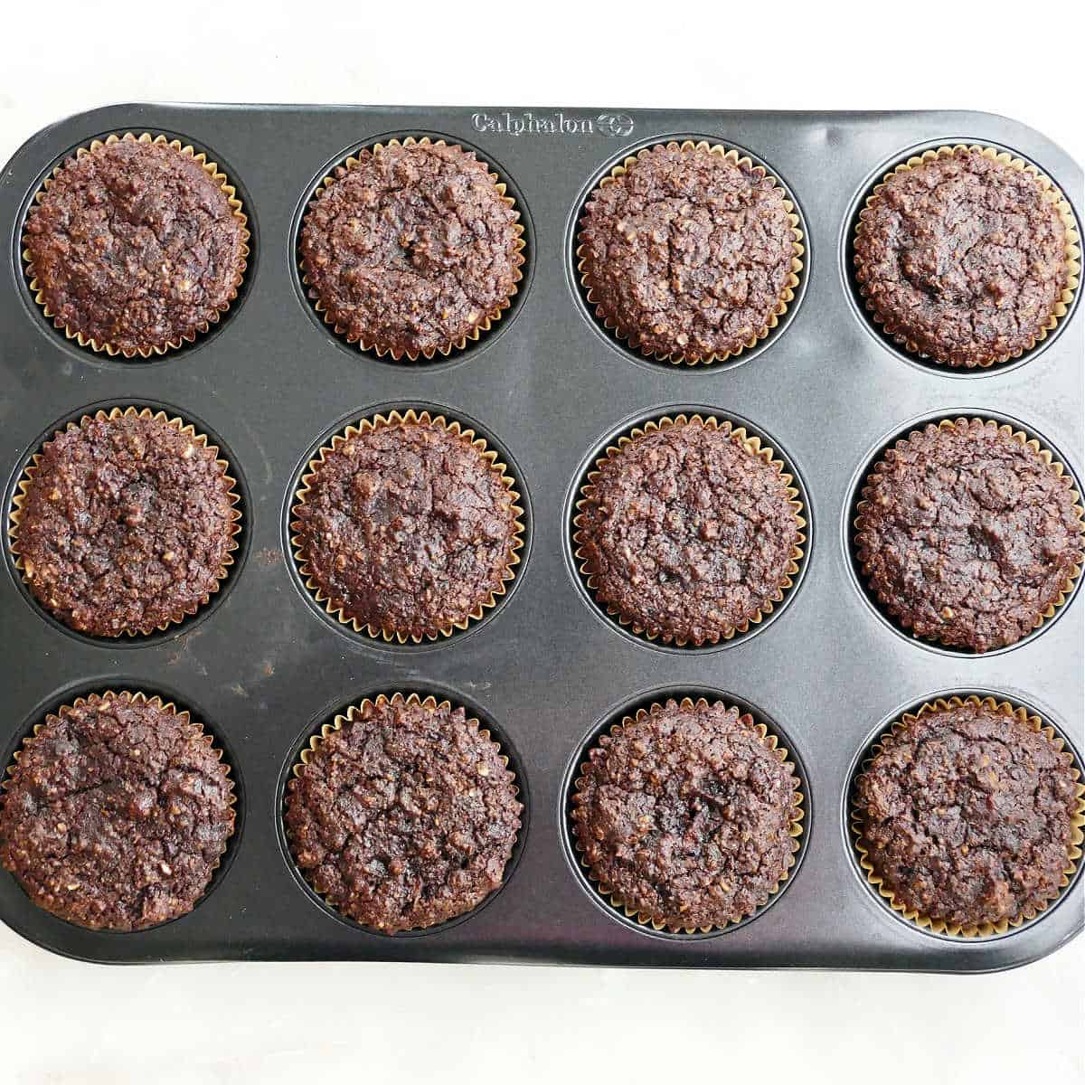 Healthy chocolate cupcakes in a cupcake tin after baking.