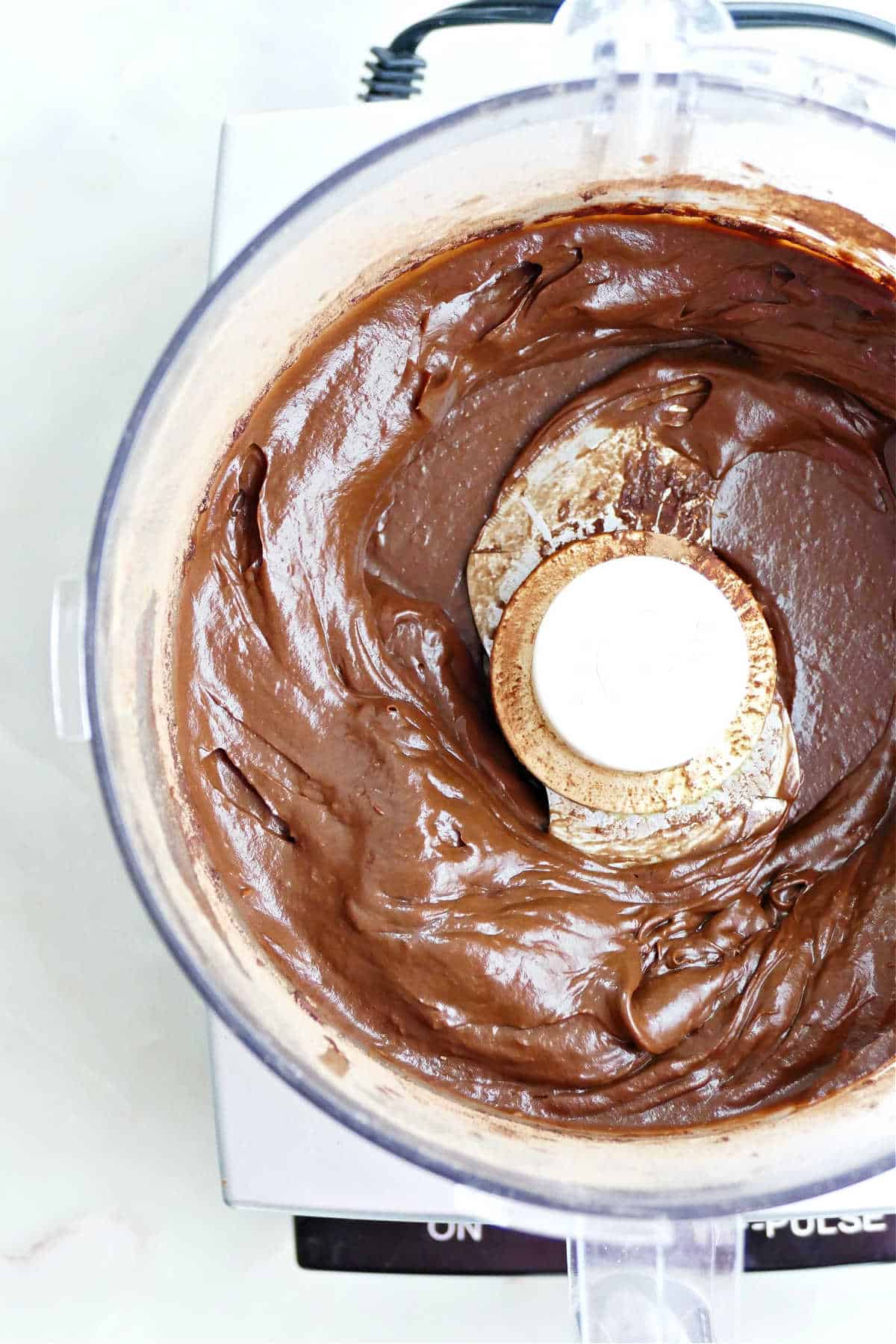 Avocado chocolate frosting after being blended in a food processor.