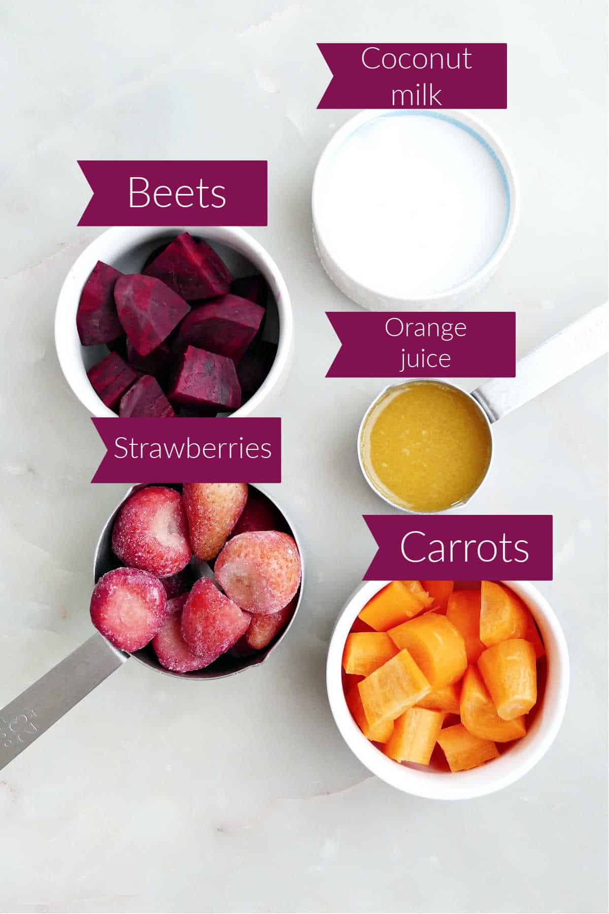 Ingredients for beet carrot smoothie on a counter with labels.