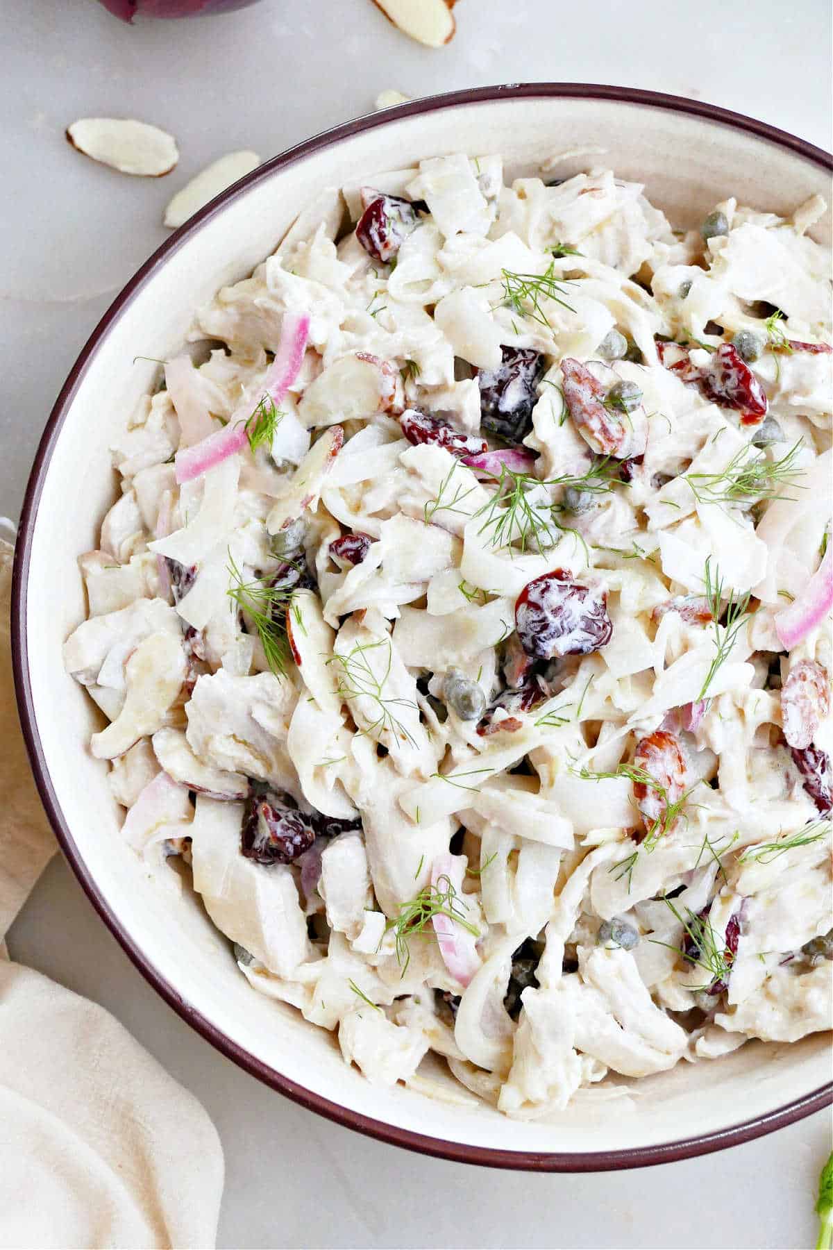 Chicken salad with pickled fennel, onion, dried cherries, and yogurt dressing in a bowl.