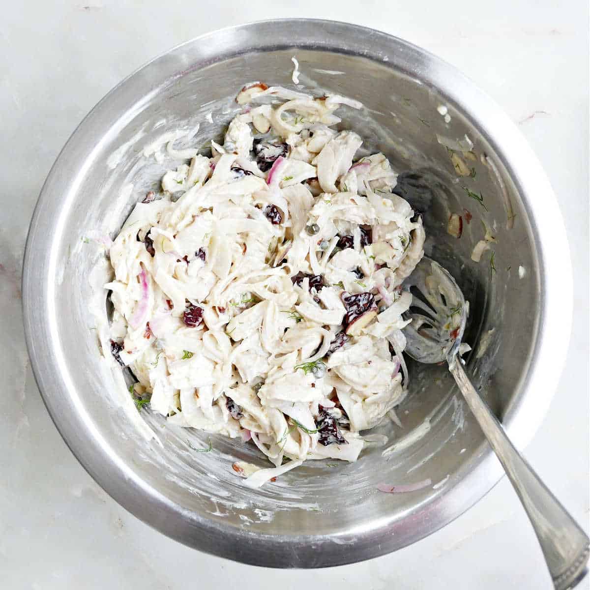 Chicken salad tossed in a yogurt dressing in a bowl.