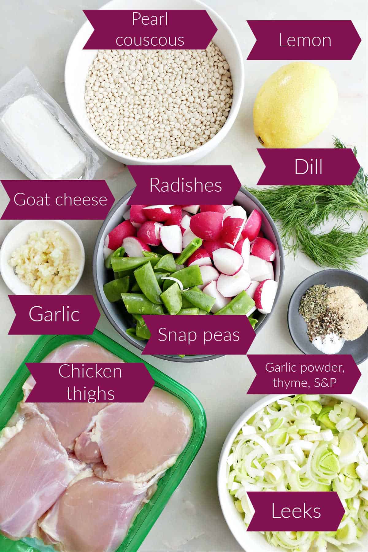 Goat cheese, couscous, lemon, dill, radishes, snap peas, garlic, spices, chicken, and leeks on a counter with labels.