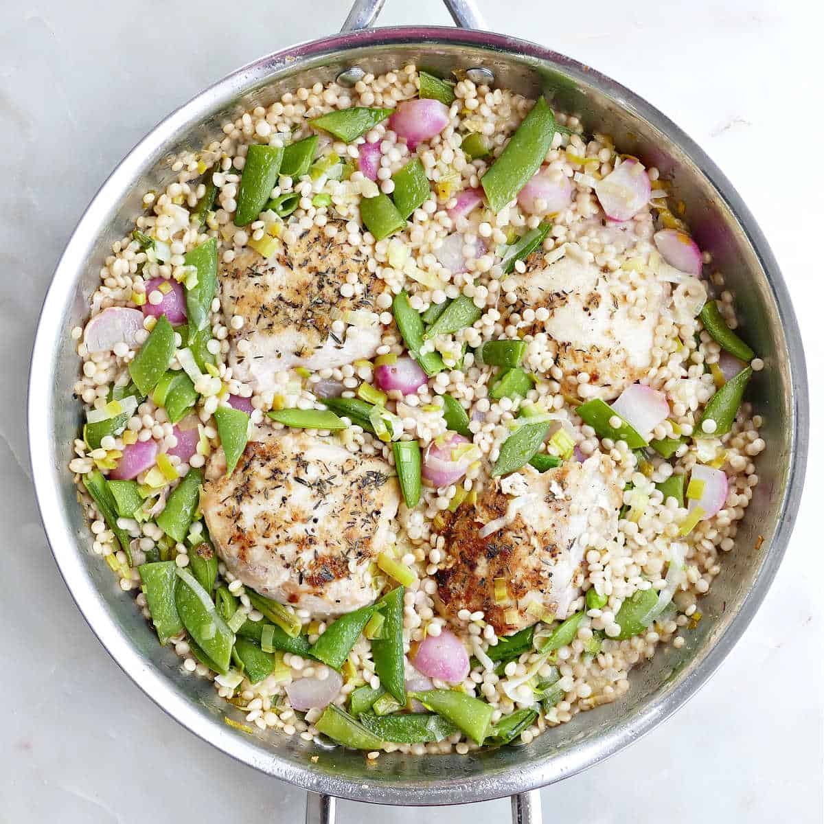 One-pot chicken, couscous, and veggies after baking in the oven.