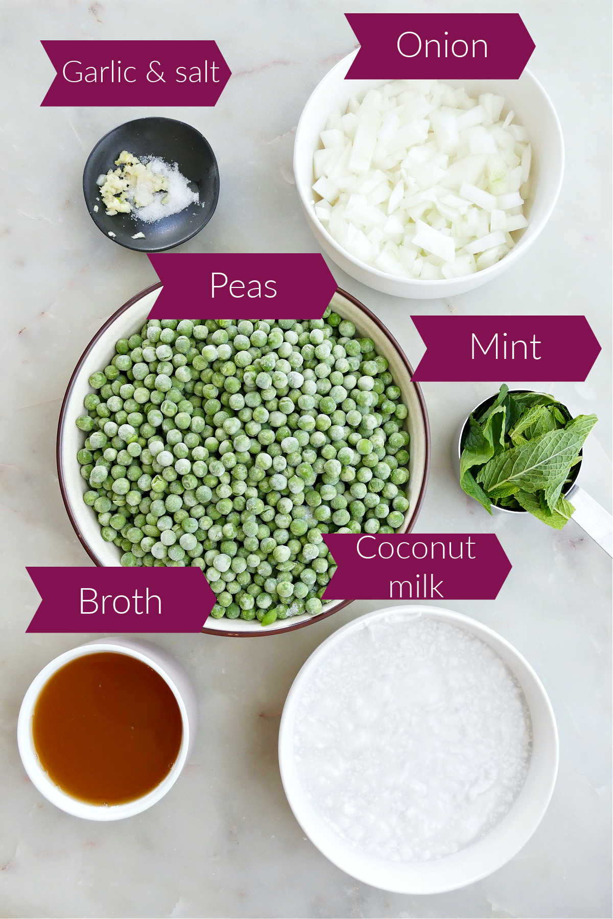Ingredients for pea soup with mint on a counter with labels.