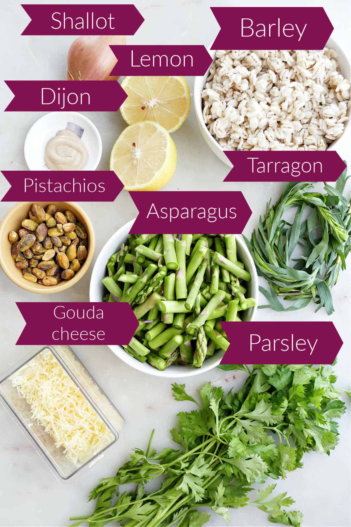 Ingredients for roasted asparagus salad on a counter with labels over them.