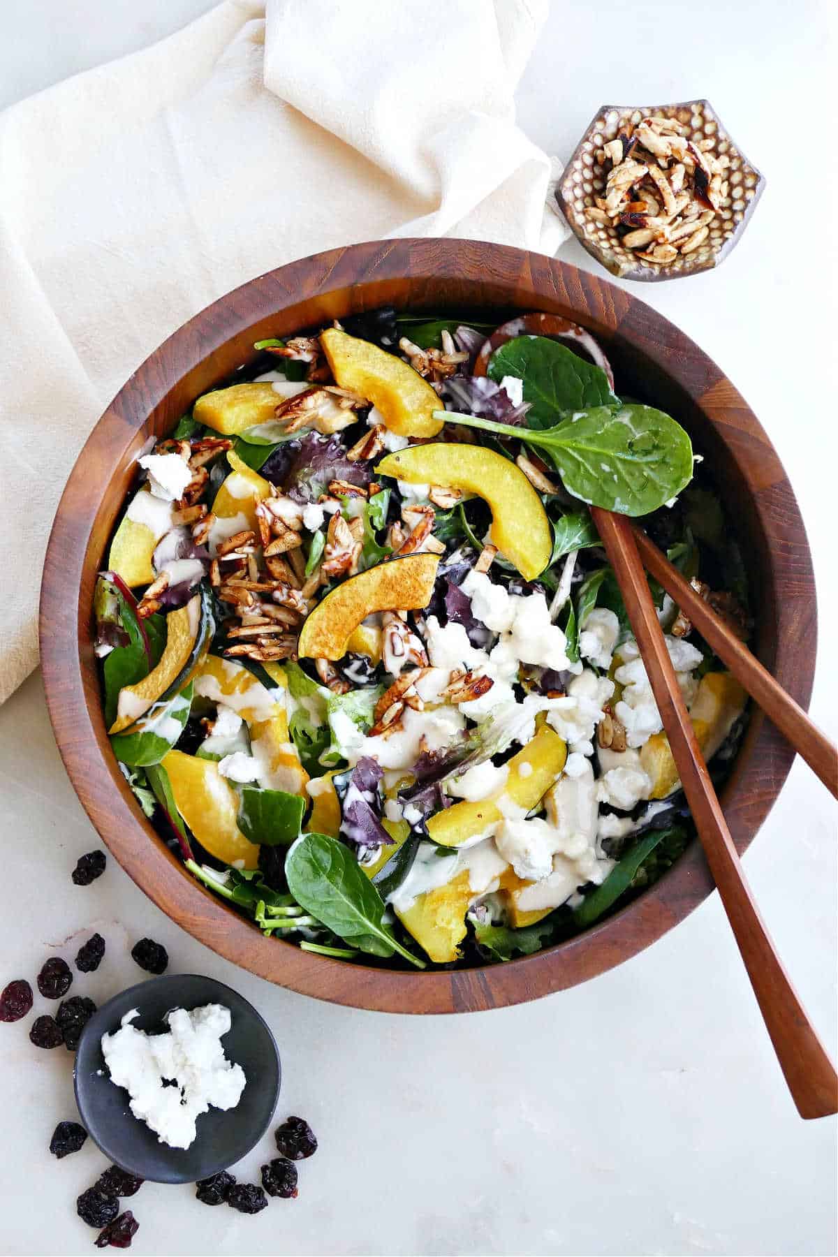 Acorn Squash Salad with Tahini Dressing in a wooden bowl.