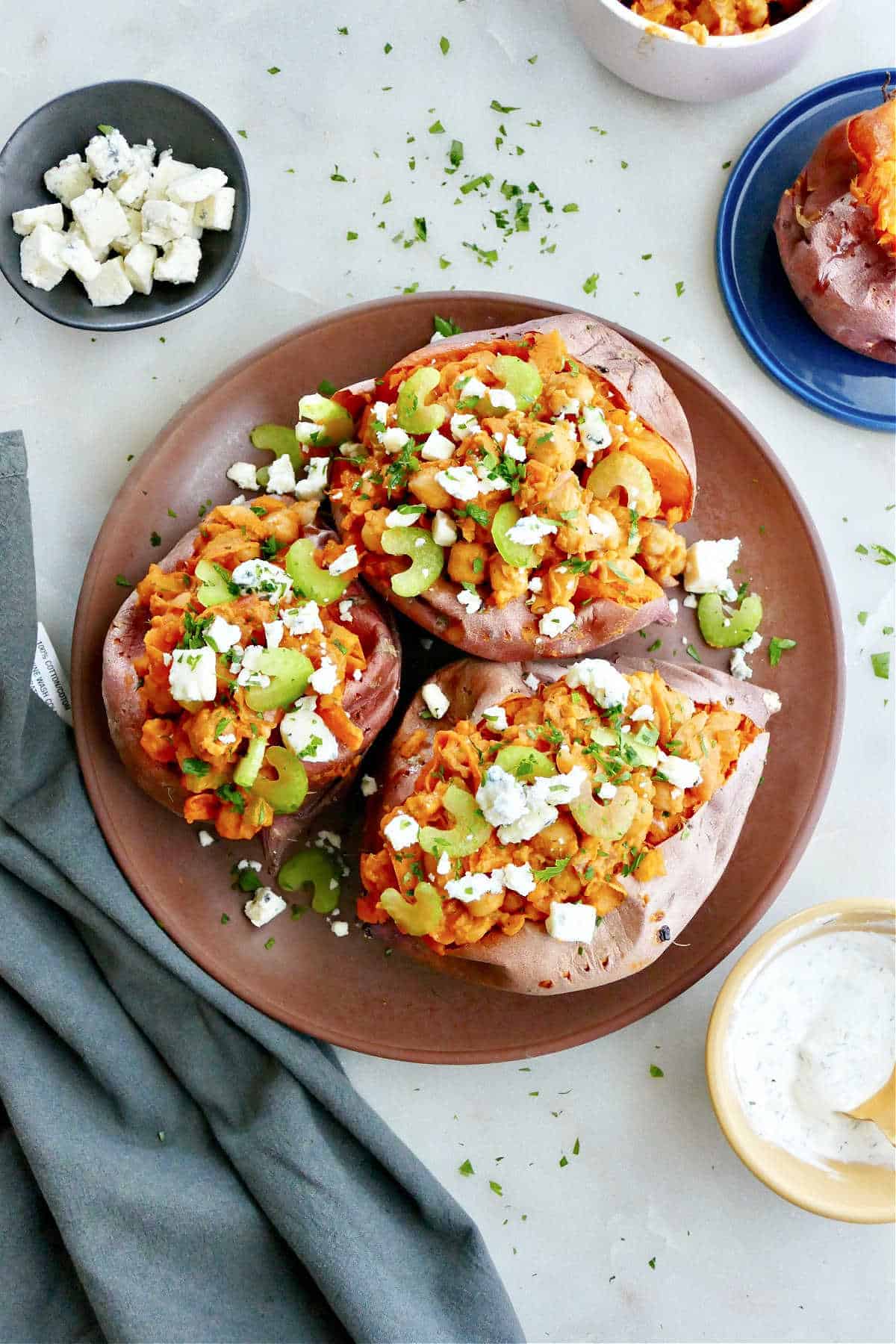 A plate of three buffalo chickpea stuffed sweet potatoes.
