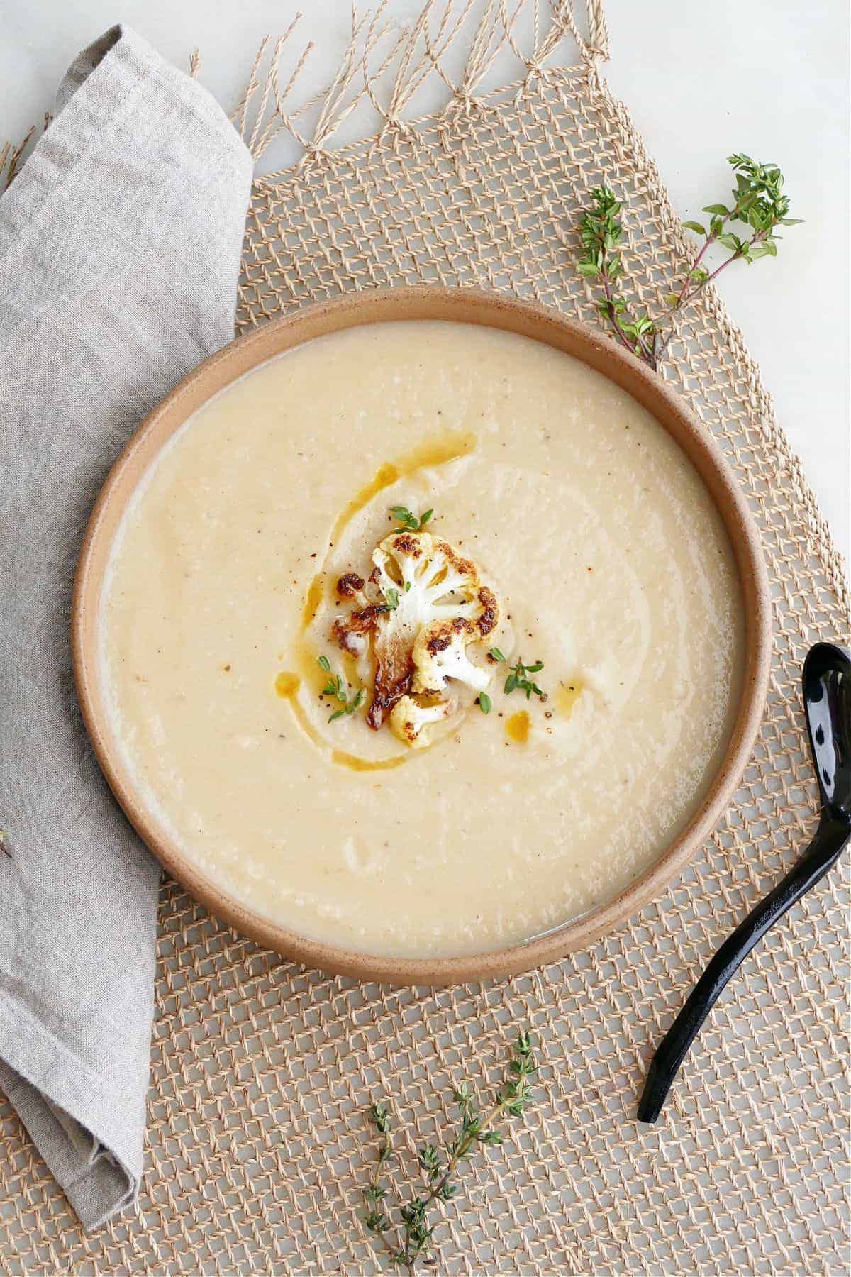 Vegan Cauliflower and Parsnip Soup topped with a caullflower floret.